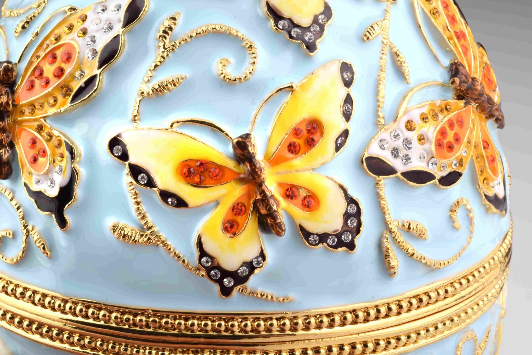 Oeuf de Fabergé bleu à fleurs jaunes